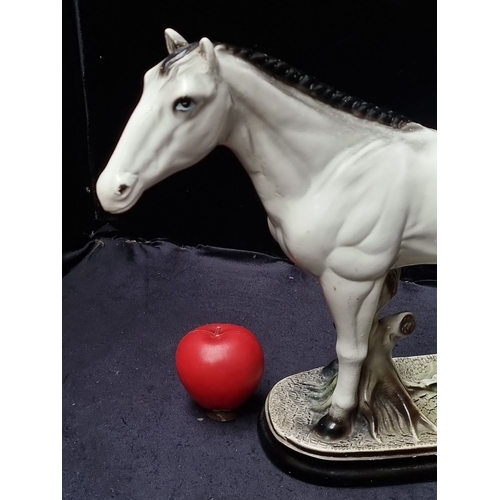 658 - A large Porcelain horse figurine on an oval base, featuring a detailed and lifelike design. Approxim... 