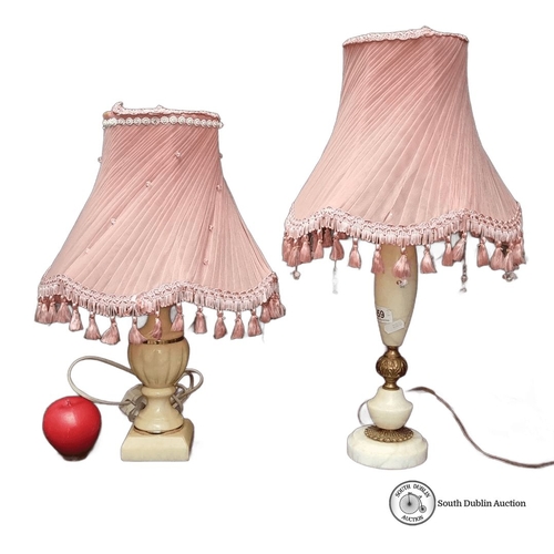 659 - Pair of vintage alabaster lamps with pleated pink fabric shades, adorned with tassels. Approximately... 