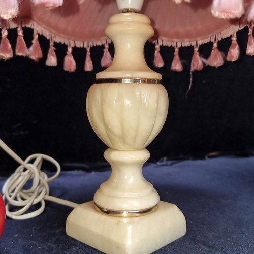 659 - Pair of vintage alabaster lamps with pleated pink fabric shades, adorned with tassels. Approximately... 