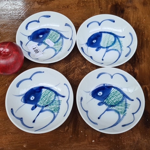 661 - Set of four hand-painted Chinese porcelain dishes, featuring blue fish motifs. Marked on the base wi... 