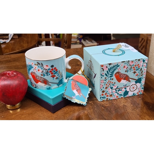 662 - Bone china mug with bird motif. Includes original decorative box.