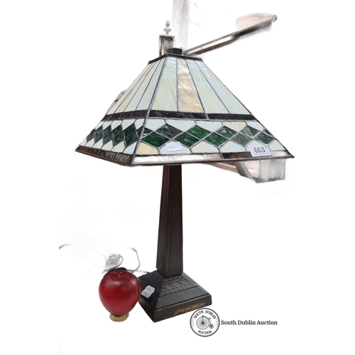 663 - Tiffany-style table lamp with stained glass shade featuring geometric green and cream patterns. Appr... 