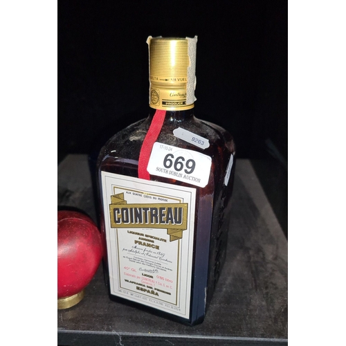 669 - 0.85L bottle of Cointreau Liqueur, produced in France. Approximately 40% alcohol by volume. Distinct... 