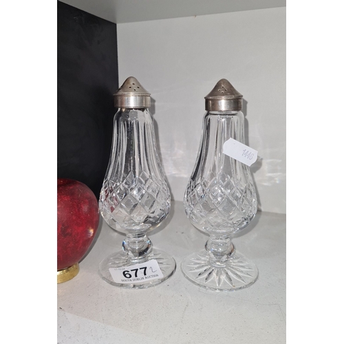 677 - Pair of Waterford crystal salt and pepper shakers with silver-plated tops, featuring an elegant cut ... 