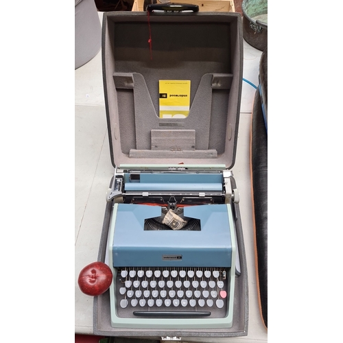 697 - Underwood 21 typewriter, vintage mechanical model with original case and manual. Features sky blue f... 