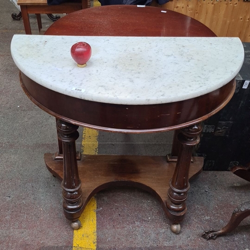 698 - Victorian mahogany console table with a white marble demi-lune top. It features intricately turned l... 