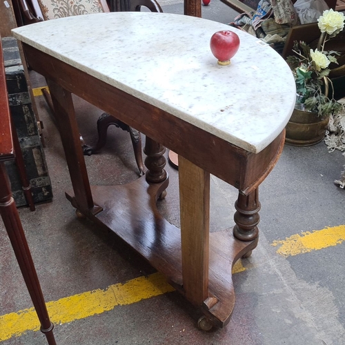 698 - Victorian mahogany console table with a white marble demi-lune top. It features intricately turned l... 