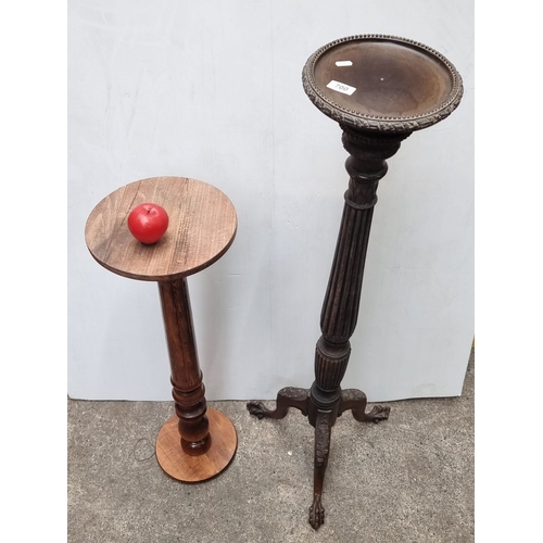 700 - Pair of wooden plant stands, one with intricate carved legs. Approximately 32 inches and 26 inches i... 