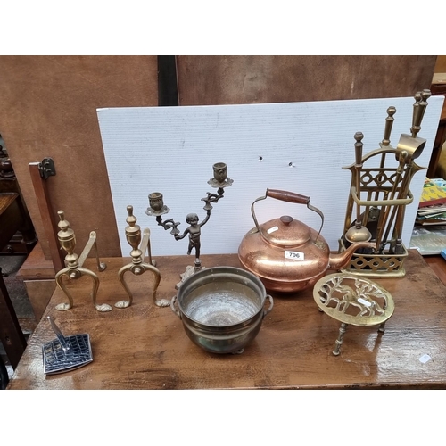 706 - Mixed lot featuring brass and copper items, including a kettle, andirons, and candle holders. Pot ma... 