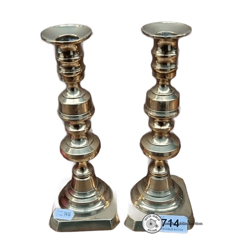 714 - Pair of brass candlesticks, approximately 10 inches tall, featuring a classic turned design with squ... 