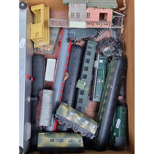 719 - Mixed lot of Märklin model trains and accessories, made in Western Germany. Includes tracks and buil... 