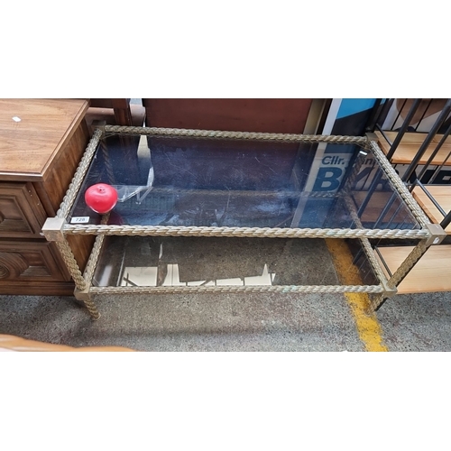 728 - Rectangular glass coffee table with ornate rope-style metal frame. Approximately 120 cm x 60 cm x 45... 