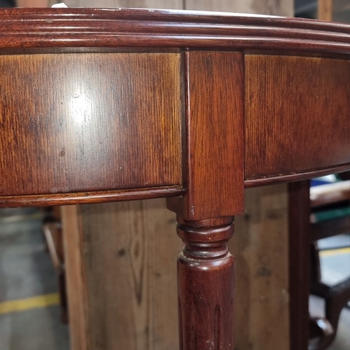 738 - A Red Mahogany demi-lune console table, Edwardian period, with tapered legs. Approximately 75cm high... 