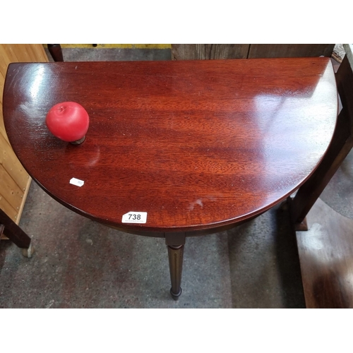 738 - A Red Mahogany demi-lune console table, Edwardian period, with tapered legs. Approximately 75cm high... 