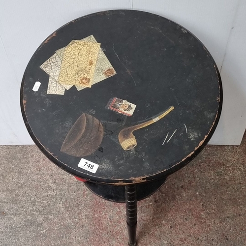 748 - Start Lot : A fabulous three legged cricket table with decoupage top, depicting maps and a pipe moti... 