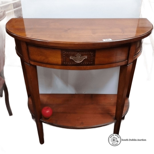 749 - Half-moon console table in polished mahogany with a single drawer. Features brass handle details. Ap... 