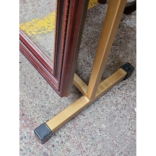 750 - Standing mirror with an ornately carved wooden frame, approximately 150cm high and 50cm wide, featur... 