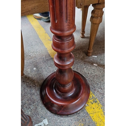 757 - Mahogany pedestal plant stand , approximately 30 inches tall, featuring a round top with a turned co... 