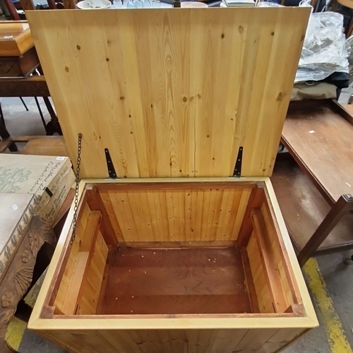 764 - A large Pine storage chest, approximately 100cm (L) x 60cm (W) x 70cm (H), with hinged lid and metal... 