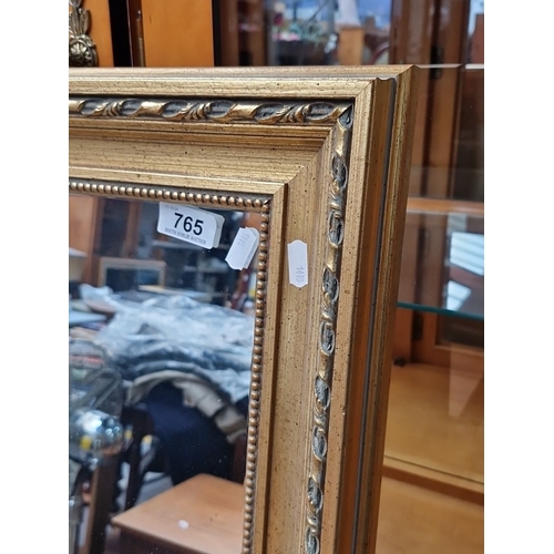 765 - Large vintage gilded mirror with ornate carved wood frame. Approximately 150 cm x 100 cm. Intricate ... 