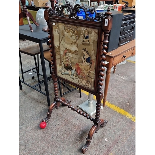 766 - Victorian walnut firescreen with intricate carved detailing, featuring a pastoral tapestry. Approxim... 