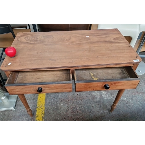 768 - Wooden table with two drawers and turned legs. Approximately 90 cm in width, 50 cm in depth, and 75 ... 