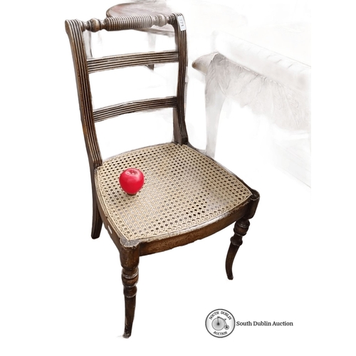 771 - Vintage cane seat chair with carved spindle backrest and wooden frame, approximately 33 in. high.