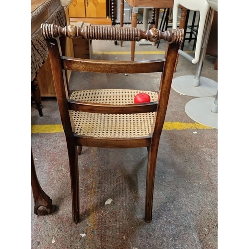 771 - Vintage cane seat chair with carved spindle backrest and wooden frame, approximately 33 in. high.