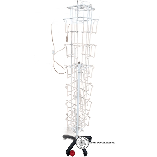 778 - White rotating metal magazine rack on wheels, approximately 170 cm high, featuring multiple display ... 