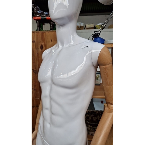779 - Male mannequin with glossy white body and natural wood articulated arms. Approximately 6 feet tall.