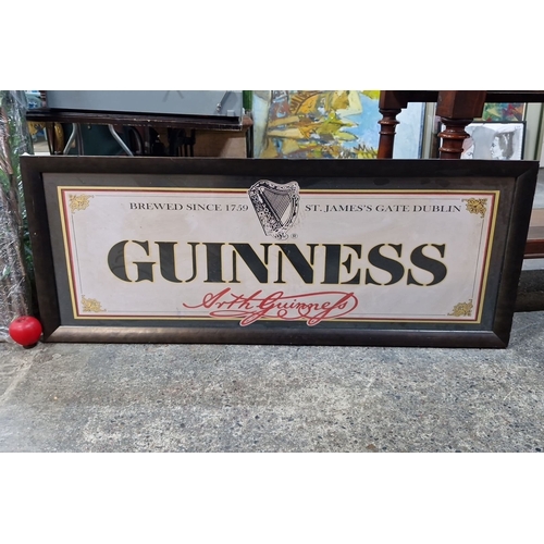 833 - A large Guinness advertising poster featuring the iconic harp logo and 'Brewed Since 1759'. Housed i... 