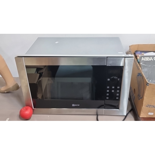 889 - Stainless steel Neff microwave oven with digital controls and a glass turntable. Model unspecified.