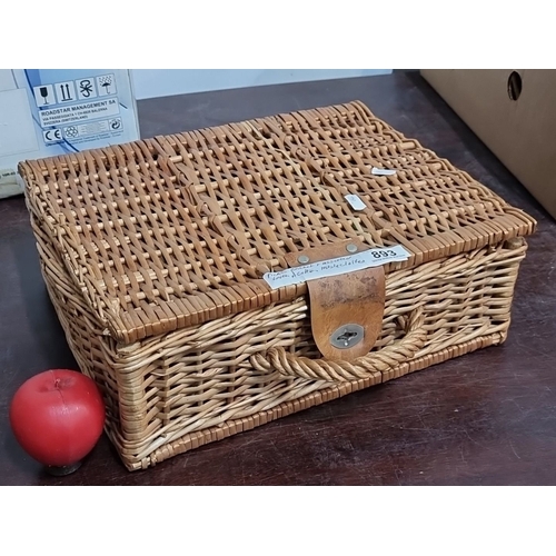 893 - Wicker picnic basket with assorted vintage linens, including embroidered and printed tablecloths. Ap... 