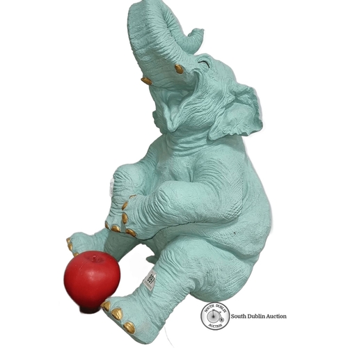 897 - Turquoise elephant sculpture with gold accents and apple detail. Approximately 25 inches high. Model... 