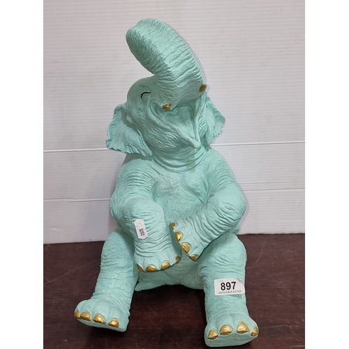 897 - Turquoise elephant sculpture with gold accents and apple detail. Approximately 25 inches high. Model... 