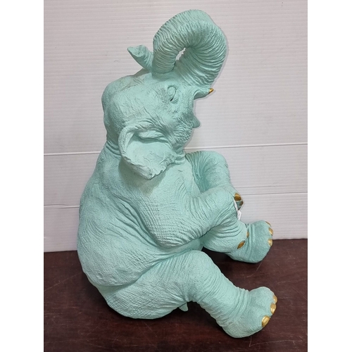 897 - Turquoise elephant sculpture with gold accents and apple detail. Approximately 25 inches high. Model... 