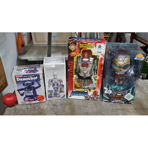 905 - Set of four battery-operated robot toys, including Dancebot and Power Robot, in original packaging. ... 