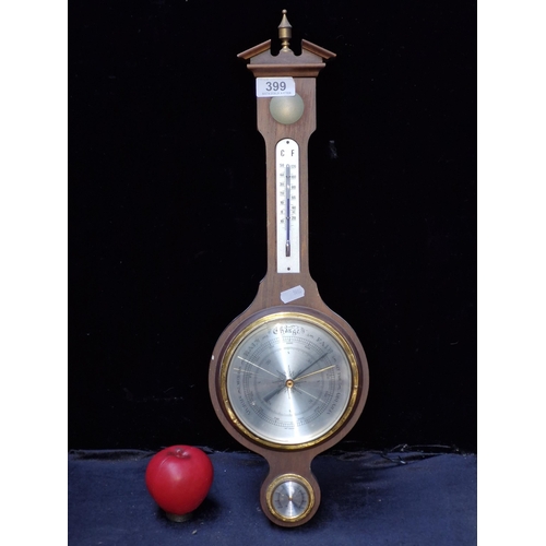 399 - A vintage West German banjo barometer with thermometer and a carved pediment to top.