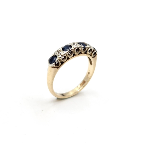 1120 - Star Lot : A pretty four stone sapphire ring with diamonds set in nine carat gold (375). Ring size -... 