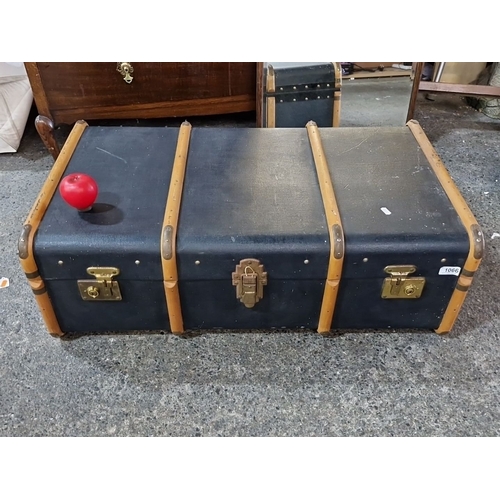 1066 - Vintage steamer trunk with wooden slats and metal hardware, featuring a lined interior. Approximatel... 