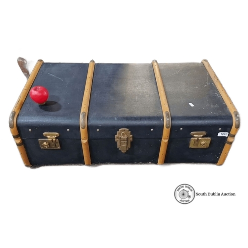 1066 - Vintage steamer trunk with wooden slats and metal hardware, featuring a lined interior. Approximatel... 