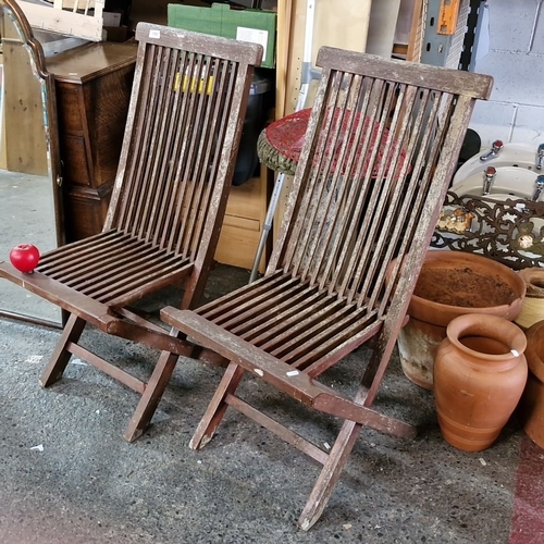 1067 - Pair of Javanbay plantation teakwood folding chairs. Approximately 90 cm high, 45 cm wide.