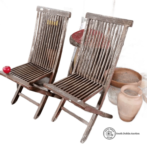 1067 - Pair of Javanbay plantation teakwood folding chairs. Approximately 90 cm high, 45 cm wide.