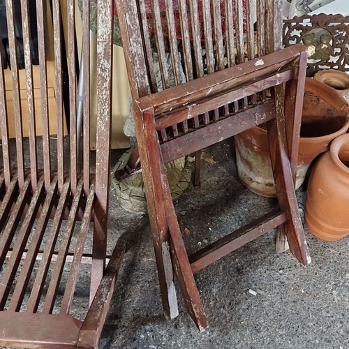 1067 - Pair of Javanbay plantation teakwood folding chairs. Approximately 90 cm high, 45 cm wide.