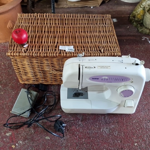 1068 - Brother XL-2230 sewing machine with foot pedal and power cord. Includes woven wicker storage basket.