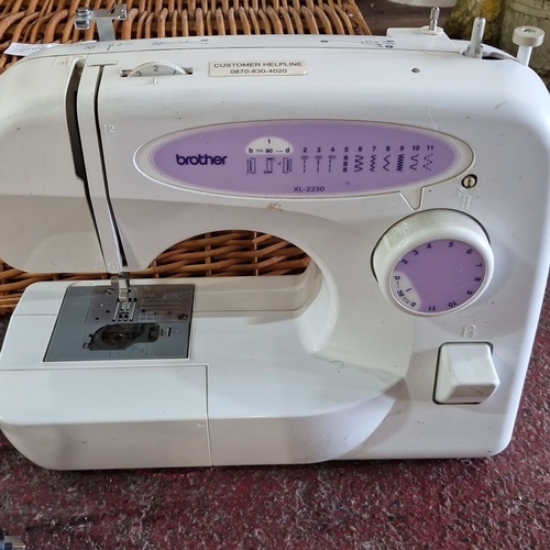 1068 - Brother XL-2230 sewing machine with foot pedal and power cord. Includes woven wicker storage basket.