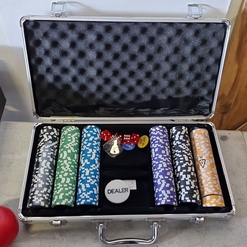 1079 - Poker set in aluminum case includes multicolored poker chips, dice, dealer button, and keys.