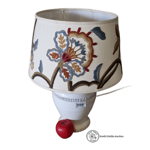 1084 - White ceramic table lamp with embroidered floral fabric shade. Approximately 14 inches tall.