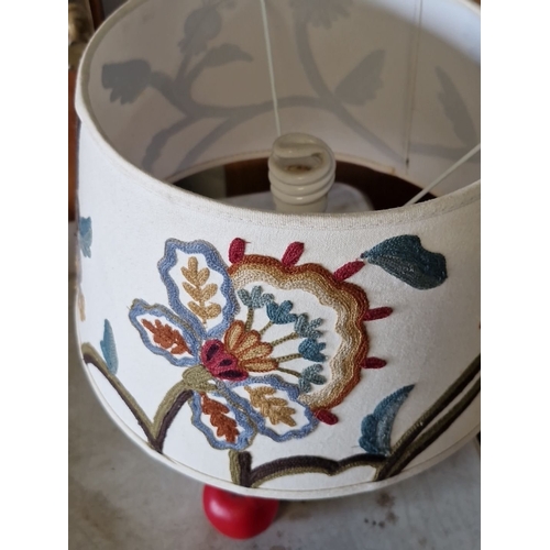 1084 - White ceramic table lamp with embroidered floral fabric shade. Approximately 14 inches tall.