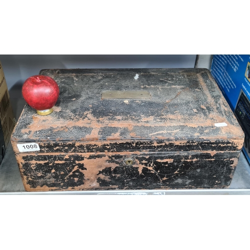 1008 - A large antique storage box in leather bound, locked with no key might contain treasure.